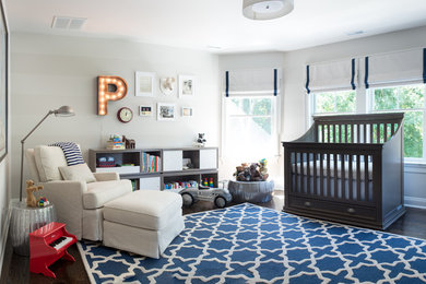 Example of a mid-sized classic boy dark wood floor nursery design in New York with gray walls