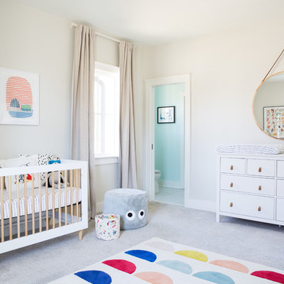 Example of a mid-sized trendy gender-neutral carpeted and gray floor nursery design in Other with beige walls