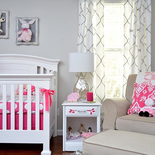 Example of a classic girl nursery design in Raleigh with gray walls