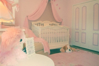 Inspiration for a small shabby-chic style girl dark wood floor nursery remodel in Miami with pink walls