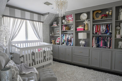 Example of a mid-sized transitional girl dark wood floor nursery design in Houston with white walls