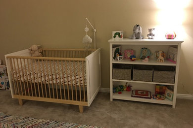 ロサンゼルスにある広いトランジショナルスタイルのおしゃれな赤ちゃん部屋 (茶色い壁、カーペット敷き、女の子用、グレーの床) の写真