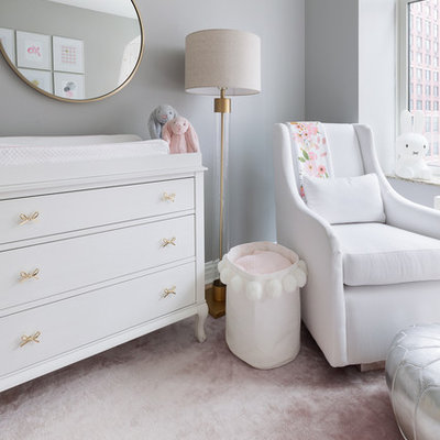 Example of a small transitional girl carpeted and pink floor nursery design in New York with gray walls