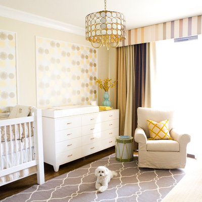 Transitional gender-neutral dark wood floor nursery photo in Los Angeles with yellow walls