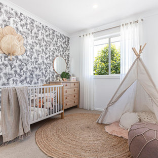 Mid-sized tropical nursery in Melbourne with white walls, carpet, beige floor and wallpaper.