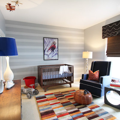 Example of a mid-sized eclectic boy carpeted nursery design in Charlotte with gray walls