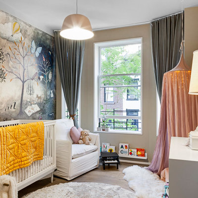 Nursery - transitional gender-neutral medium tone wood floor and brown floor nursery idea in New York with beige walls