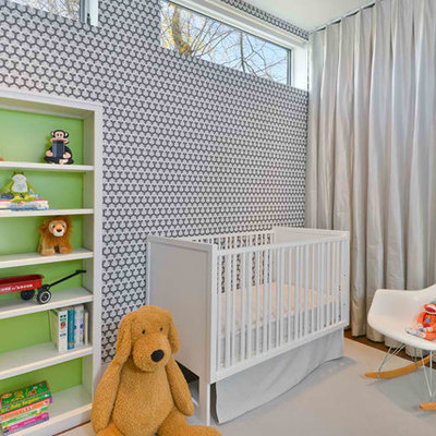 Trendy gender-neutral medium tone wood floor nursery photo in Chicago with multicolored walls