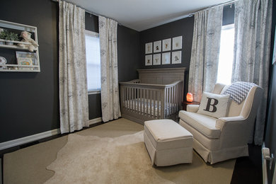 Inspiration for a mid-sized transitional gender-neutral dark wood floor and brown floor nursery remodel in Cleveland with gray walls