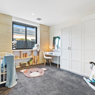 This is an example of a contemporary gender-neutral nursery in Melbourne with white walls, carpet and grey floor.