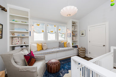 Mid-sized transitional gender-neutral medium tone wood floor and brown floor nursery photo in Boston with gray walls