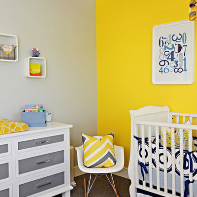 Trendy gender-neutral carpeted nursery photo in Orange County with yellow walls