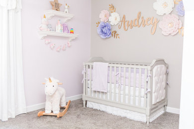 Small girl carpeted and beige floor nursery photo in Raleigh with multicolored walls