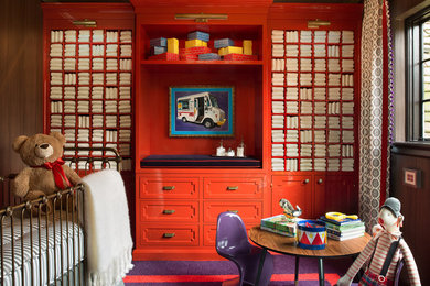 Example of a mid-sized trendy gender-neutral carpeted nursery design in Chicago with red walls