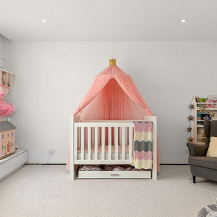Inspiration for a mid-sized transitional nursery for girls in Melbourne with white walls, carpet and white floor.