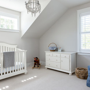 Mid-sized elegant boy carpeted and beige floor nursery photo in Charleston with beige walls