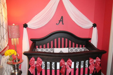 Inspiration for a transitional girl nursery remodel in San Francisco with pink walls