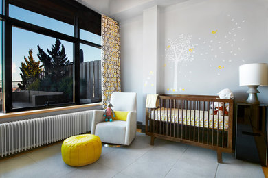 Example of a mid-sized minimalist gender-neutral nursery design in New York with gray walls