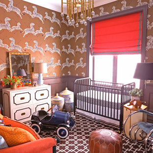 This is an example of a bohemian nursery for boys in Chicago with brown walls and carpet.