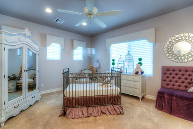 This is an example of a large traditional nursery for girls in Orange County with purple walls and carpet.