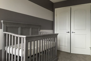 Example of a mid-sized transitional gender-neutral carpeted and gray floor nursery design in Edmonton with gray walls