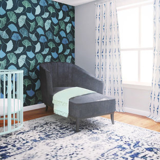 Nursery - small contemporary gender-neutral medium tone wood floor and wallpaper nursery idea in Los Angeles with blue walls