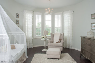 Example of a mid-sized cottage chic girl dark wood floor nursery design in Austin