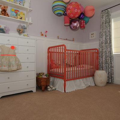 Inspiration for a mid-sized transitional girl carpeted nursery remodel in Calgary with purple walls