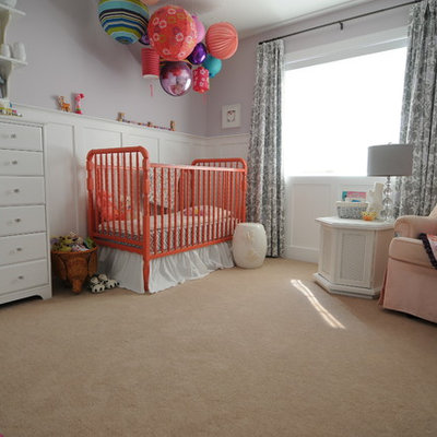 Example of a mid-sized transitional girl carpeted nursery design in Calgary with purple walls