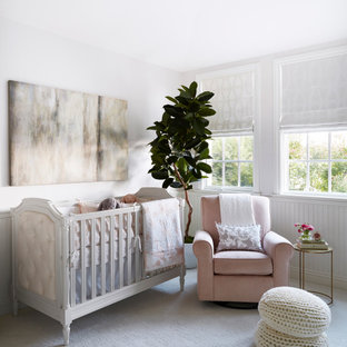 Example of a classic girl carpeted and white floor nursery design in Los Angeles with gray walls