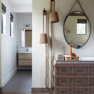 Example of a mid-sized eclectic gender-neutral medium tone wood floor and beige floor nursery design in Denver with white walls