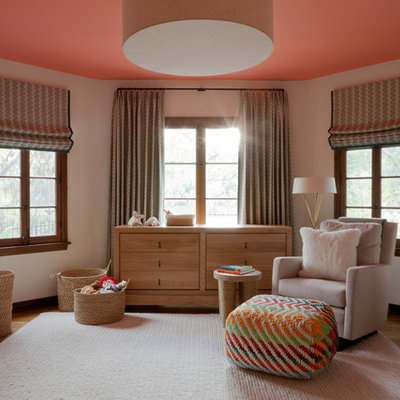 Nursery - transitional gender-neutral medium tone wood floor and beige floor nursery idea in Los Angeles with white walls