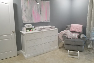 Inspiration for a medium sized modern nursery for girls in New York with multi-coloured walls, carpet and beige floors.