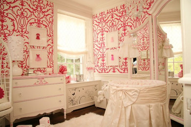 Design ideas for a medium sized classic nursery for girls in Toronto with pink walls and dark hardwood flooring.