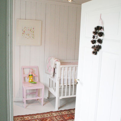 Inspiration for a scandinavian girl nursery remodel in Other with white walls