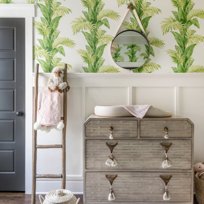 Inspiration for a transitional girl medium tone wood floor and brown floor nursery remodel in Charlotte with white walls