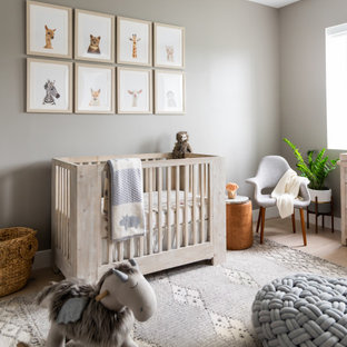 Mid-sized beach style gender-neutral beige floor and light wood floor nursery photo in Miami with beige walls