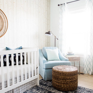 Inspiration for a small transitional boy light wood floor nursery remodel in Salt Lake City with beige walls