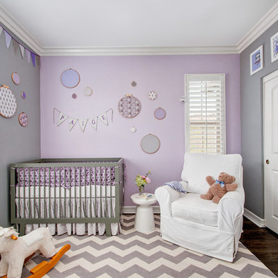 Example of a mid-sized transitional girl dark wood floor nursery design in San Diego with purple walls