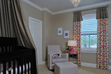 Example of a classic girl carpeted nursery design in Houston with beige walls