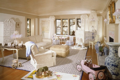 Example of a large classic gender-neutral light wood floor nursery design in Orange County with white walls