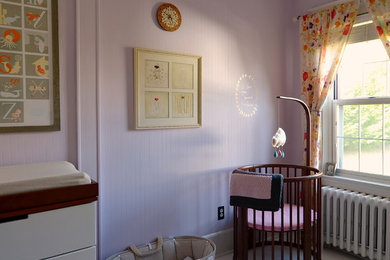 Design ideas for a scandinavian nursery for girls in New York with pink walls and painted wood flooring.