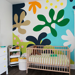 Bohemian gender neutral nursery in Cincinnati with white walls, dark hardwood flooring and brown floors.