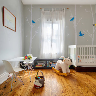 Inspiration for a small contemporary gender-neutral medium tone wood floor nursery remodel in Toronto with gray walls