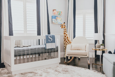 Nursery - mid-sized modern boy dark wood floor and white floor nursery idea in Los Angeles with white walls