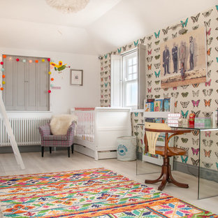 Contemporary nursery in London with multi-coloured walls and beige floors.