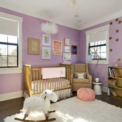 Large transitional girl dark wood floor nursery photo in Orlando with purple walls