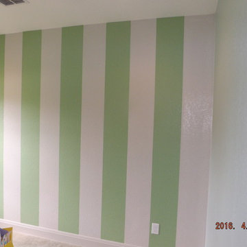 Nursery with striped accent wall