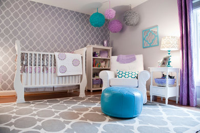 Mid-sized trendy medium tone wood floor nursery photo in Richmond with purple walls