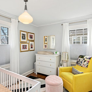 Example of an eclectic gender-neutral dark wood floor and brown floor nursery design in Kansas City with gray walls